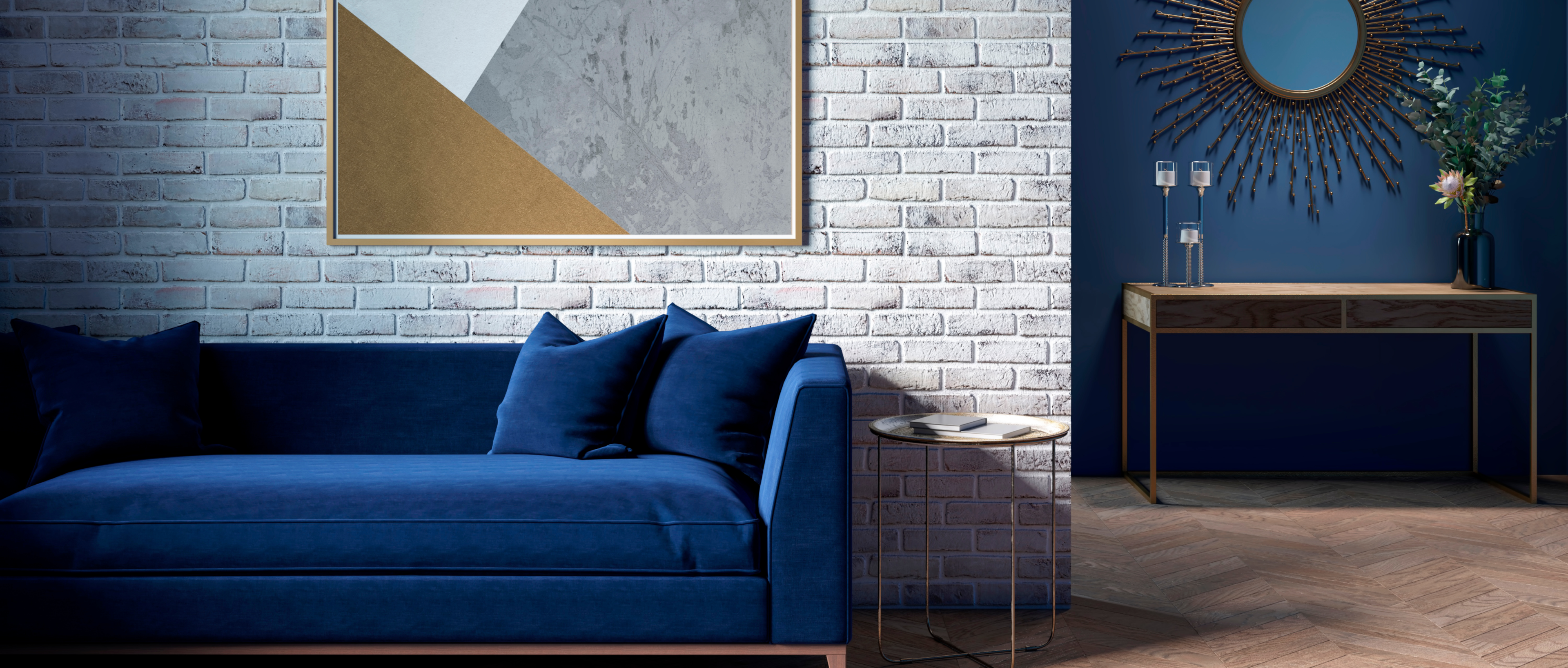 A modern living room with a dark blue sofa next to a brick wall and a poster.