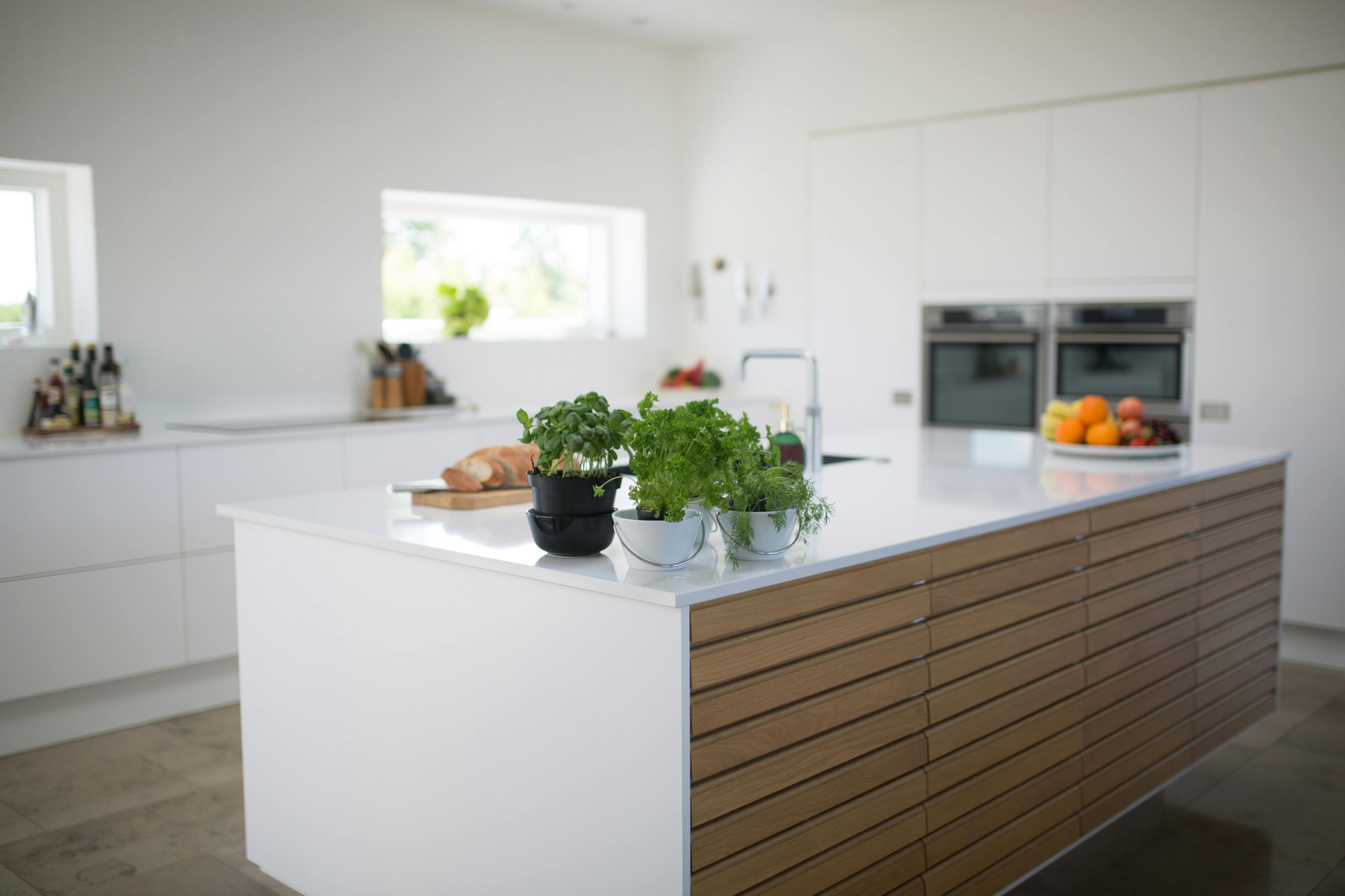 Cozy kitchen renovation with white shaker cabinets, a farmhouse sink, and pendant lighting.