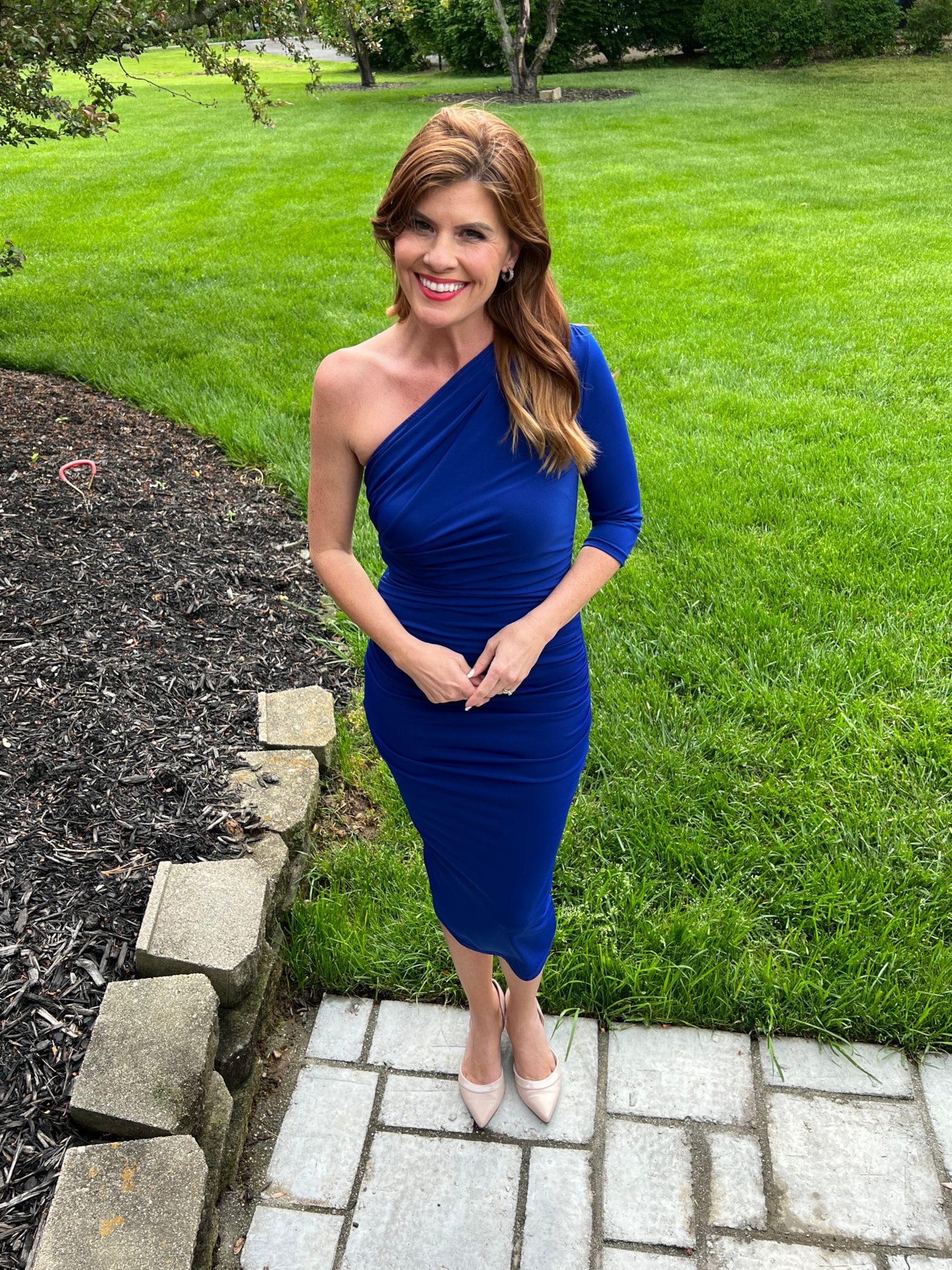 Love the neck on this with the one shoulder look. Also the bright blue and below the knee hem is classic