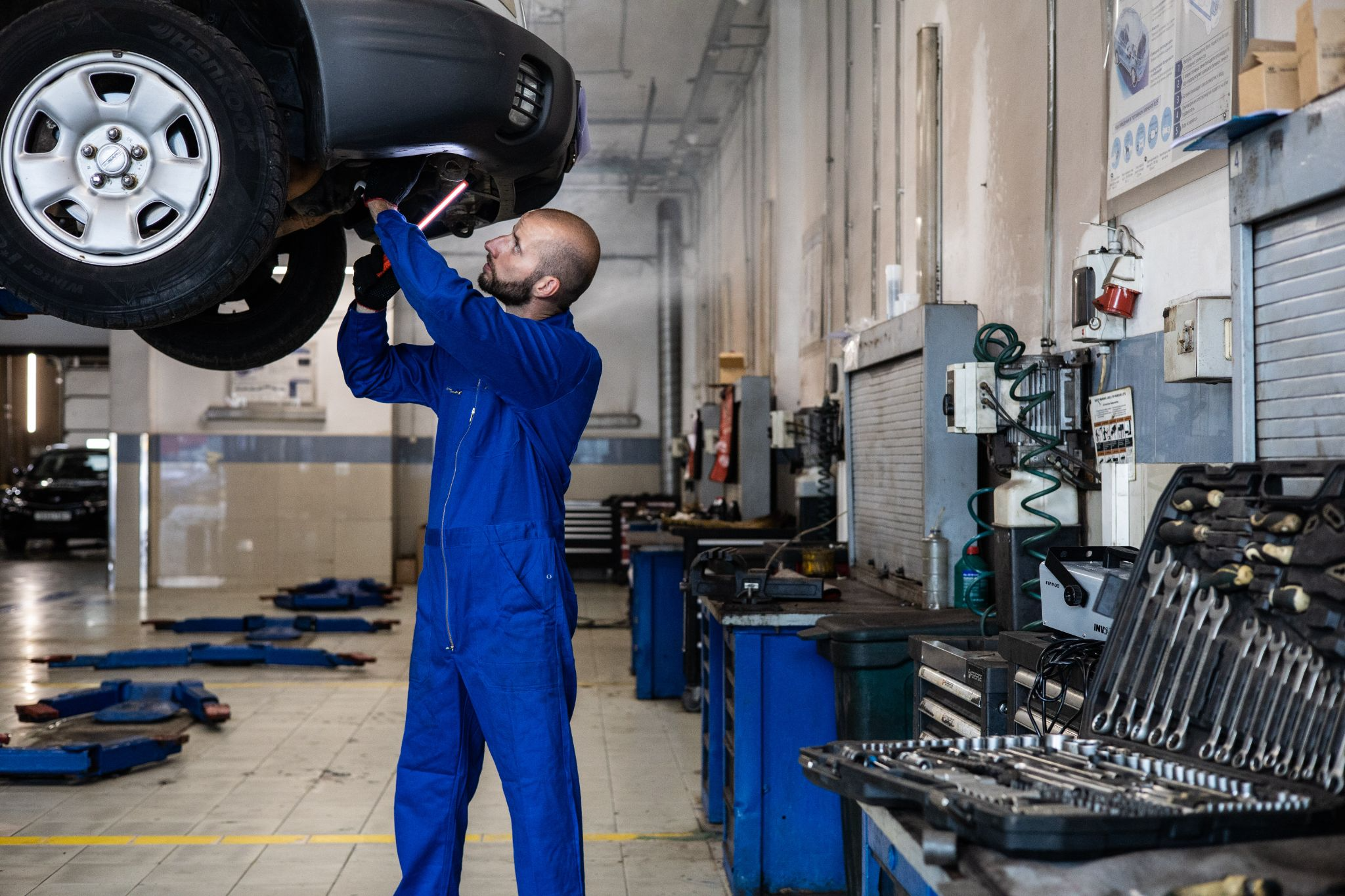 Mechanic working on the inside of a vehicle