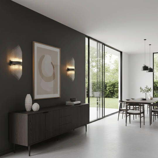 Contemporary dining room lighting with ribbed glass wall sconces casting warm light on a dark feature wall.