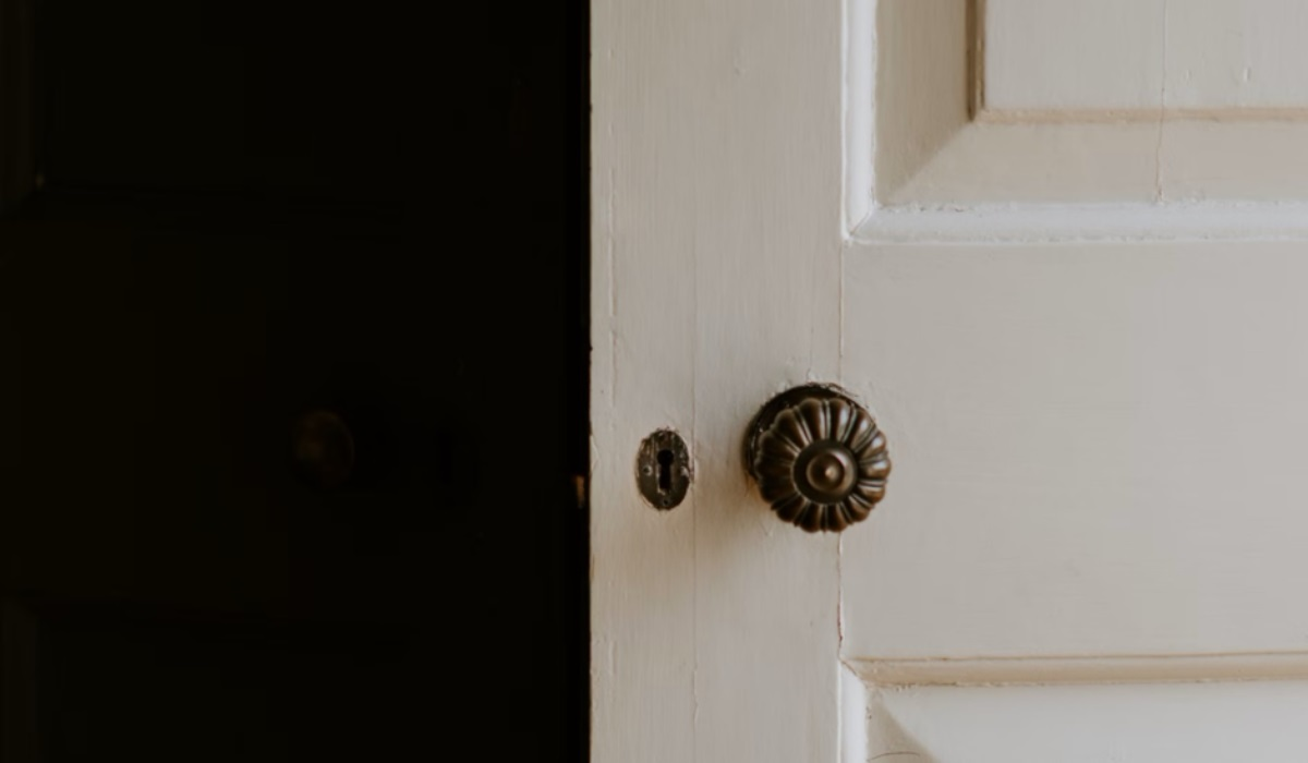 Edwardian period door furniture - brass flower door knob on white door - antique door handles 