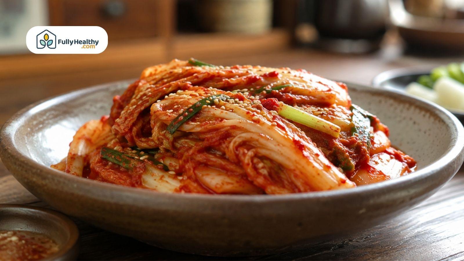Traditional kimchi made with napa cabbage served in a ceramic bowl..