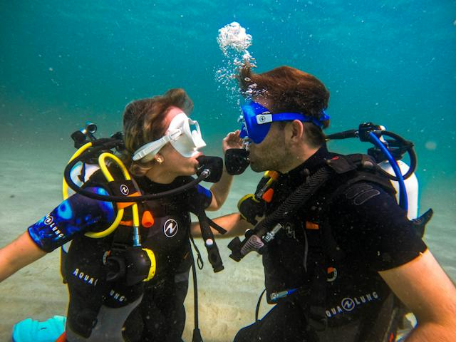 Couple Scuba Diving Looking at Each Other