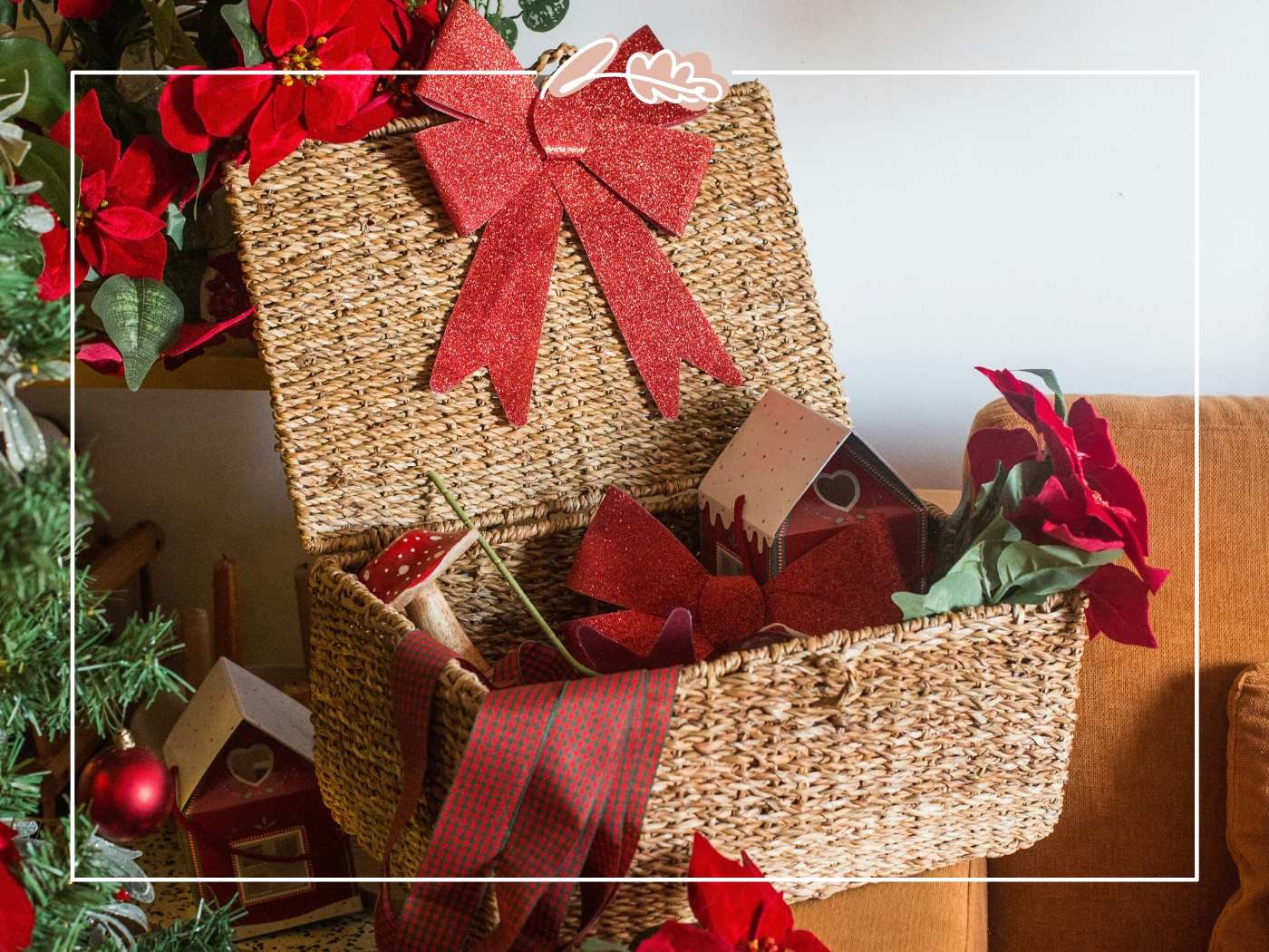 Christmas-themed basket with red ribbon and decorations.