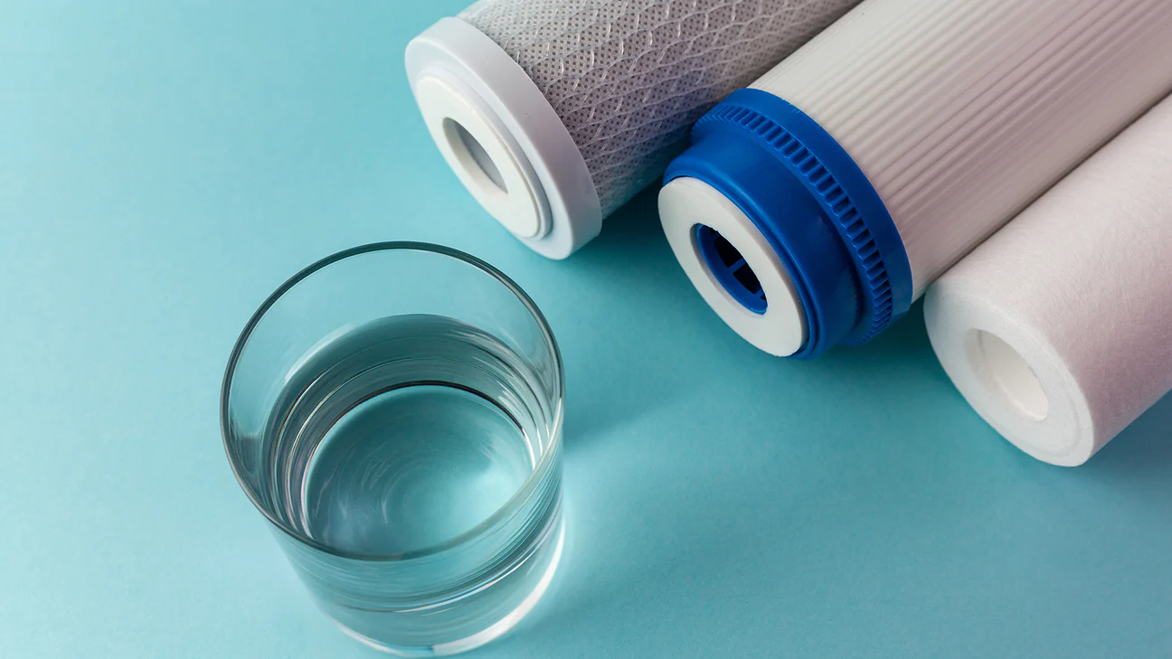 Filter cartridges next to clean glass water 