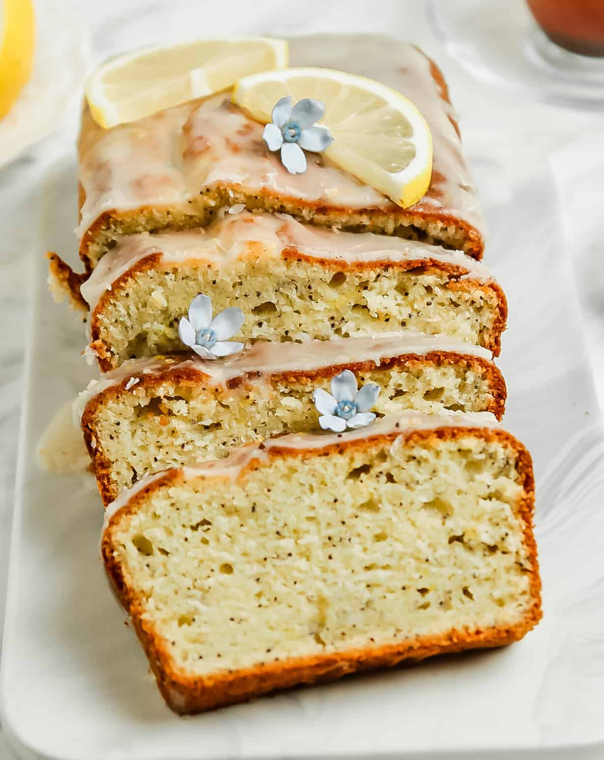 sliced lemon loaf cake on a plate