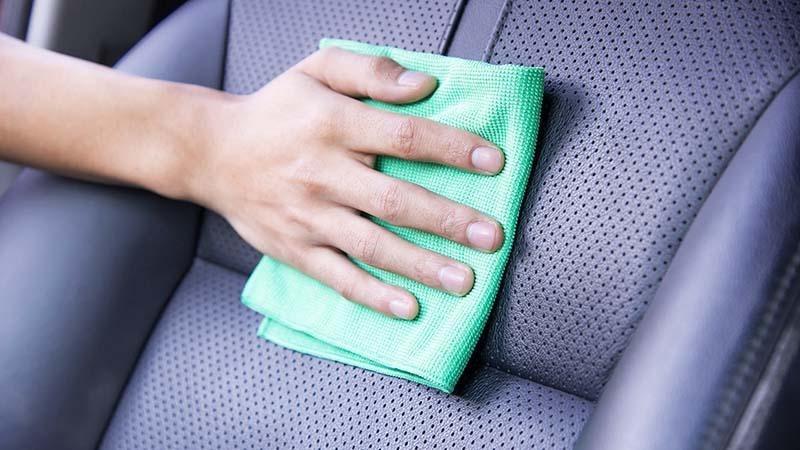 Woman wiping down car seats