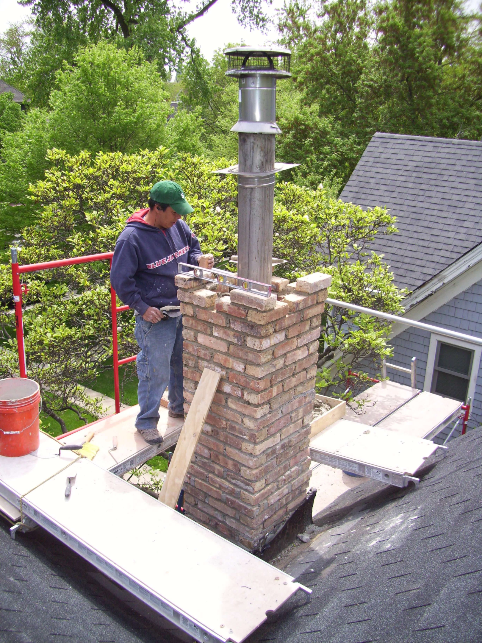 A person maintaining a chimney