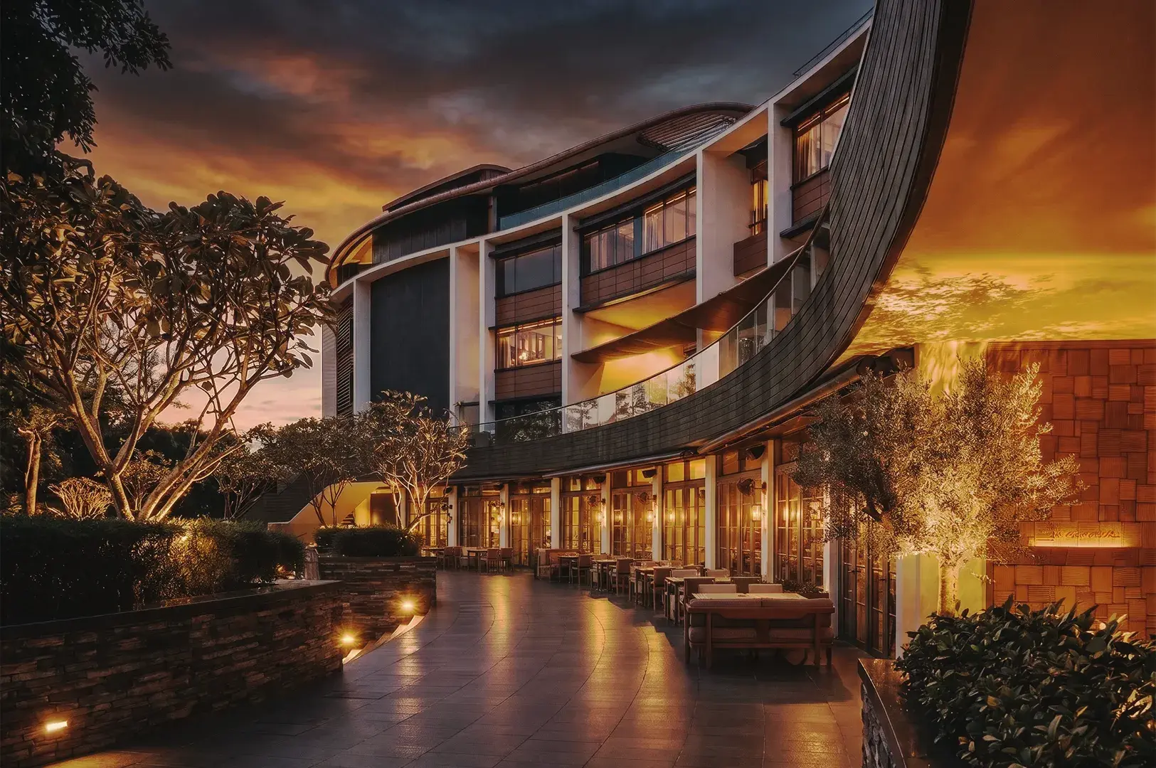 Grand luxury hotel lobby featuring marble floors, sweeping staircase, towering columns, and sophisticated interior design
