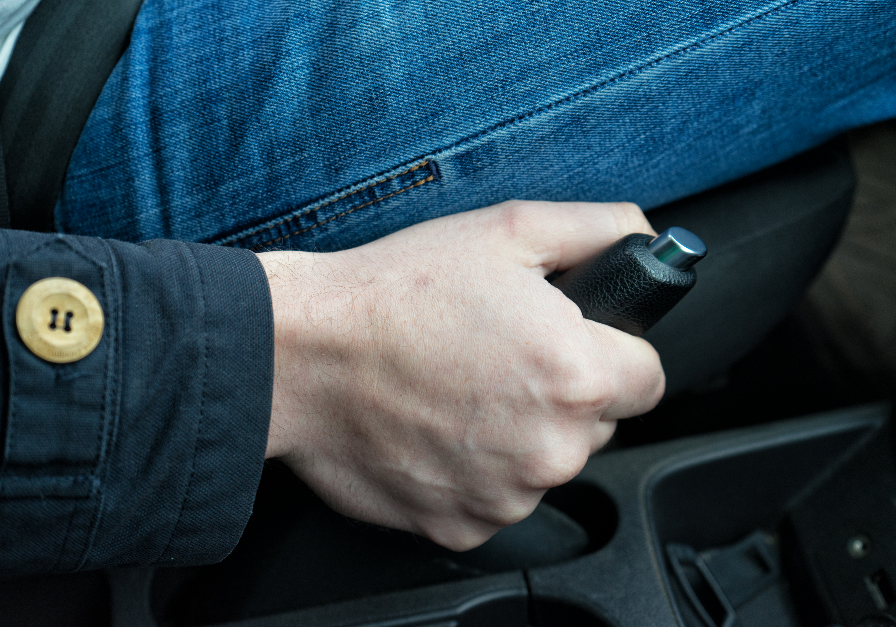 A car parked with parking brake engaged and engine oil topped up