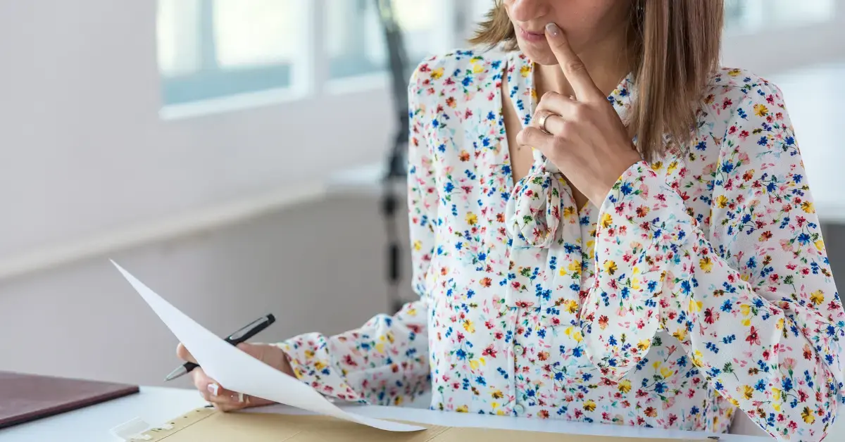 Woman reviewing a CP501 notice with tax records and payment documents at her desk