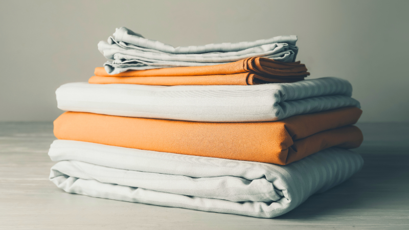 A stack of folded Pima bedsheets sitting on top of each other