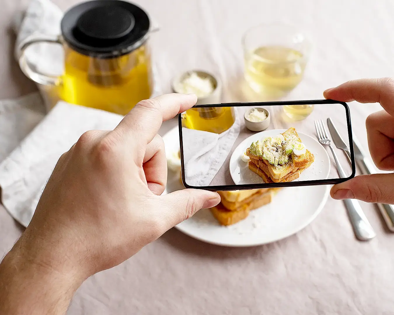 Customer photographing restaurant food with smartphone for social media and restaurant visual marketing