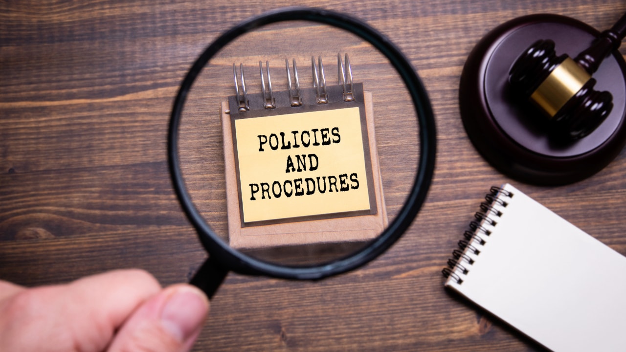 policies and procedures post-it note, magnifying glass