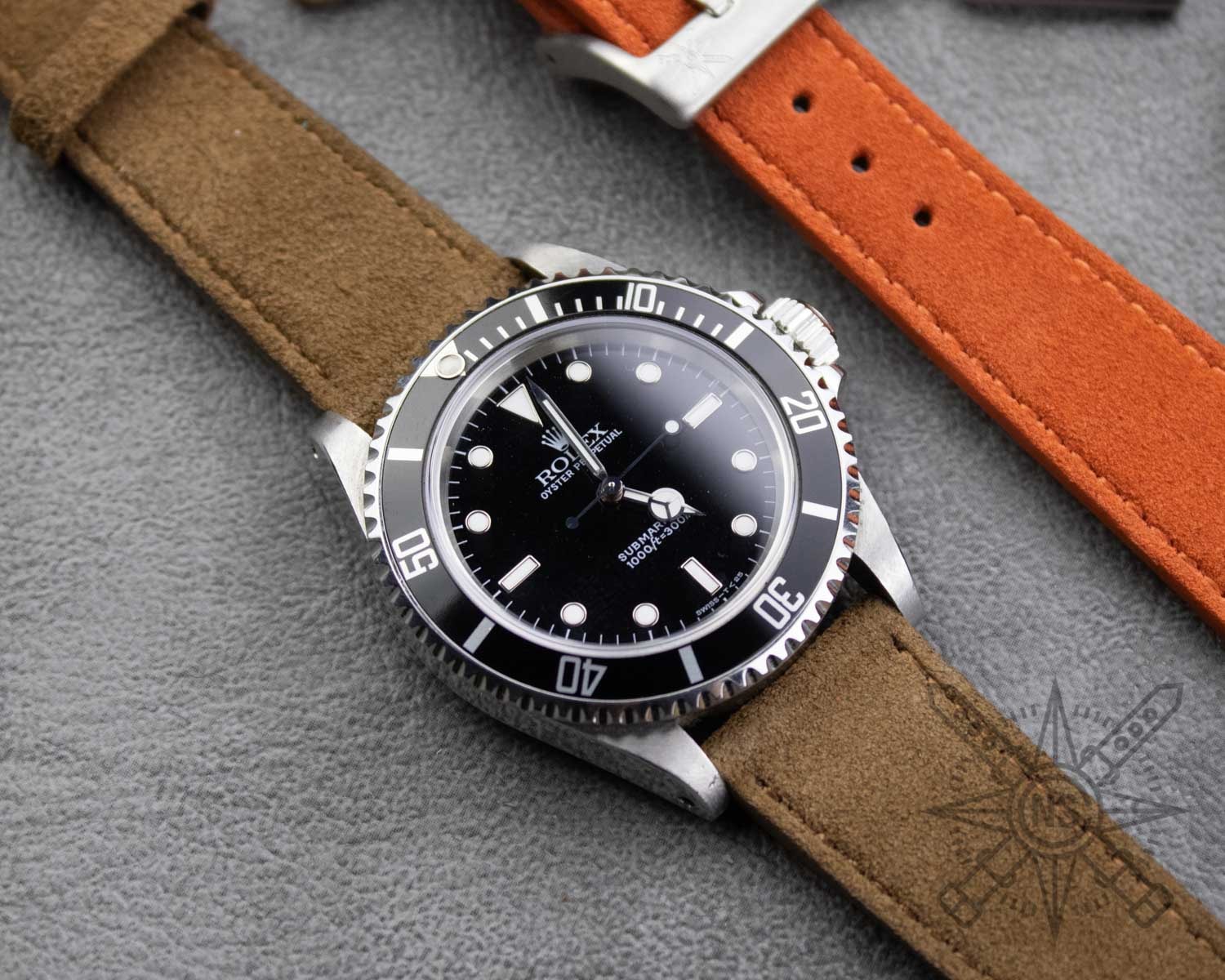 A close-up of a brown suede watch strap showcasing its soft texture.