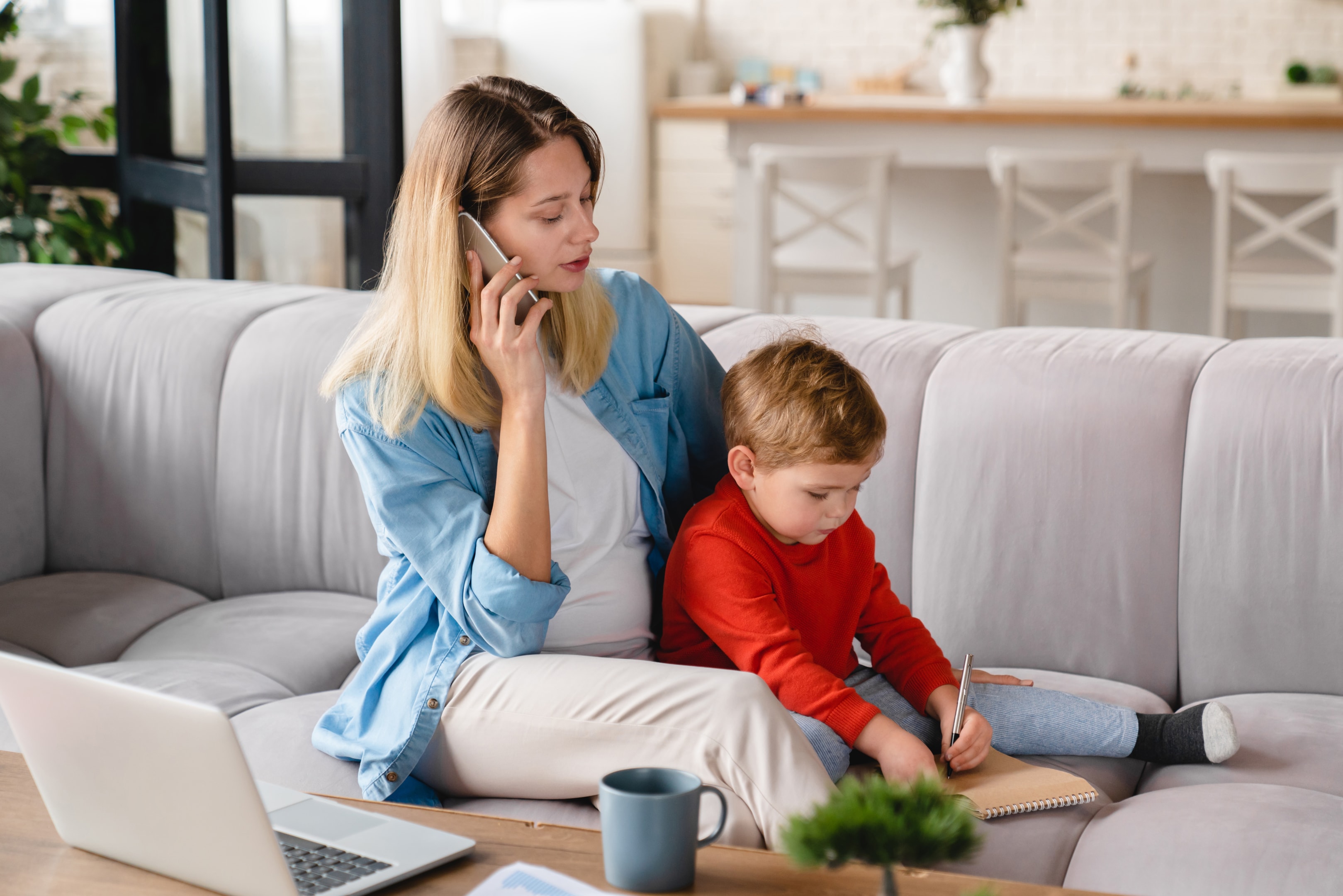 Caucasian beautiful pregnant stay at home mother working remotely distant job on laptop