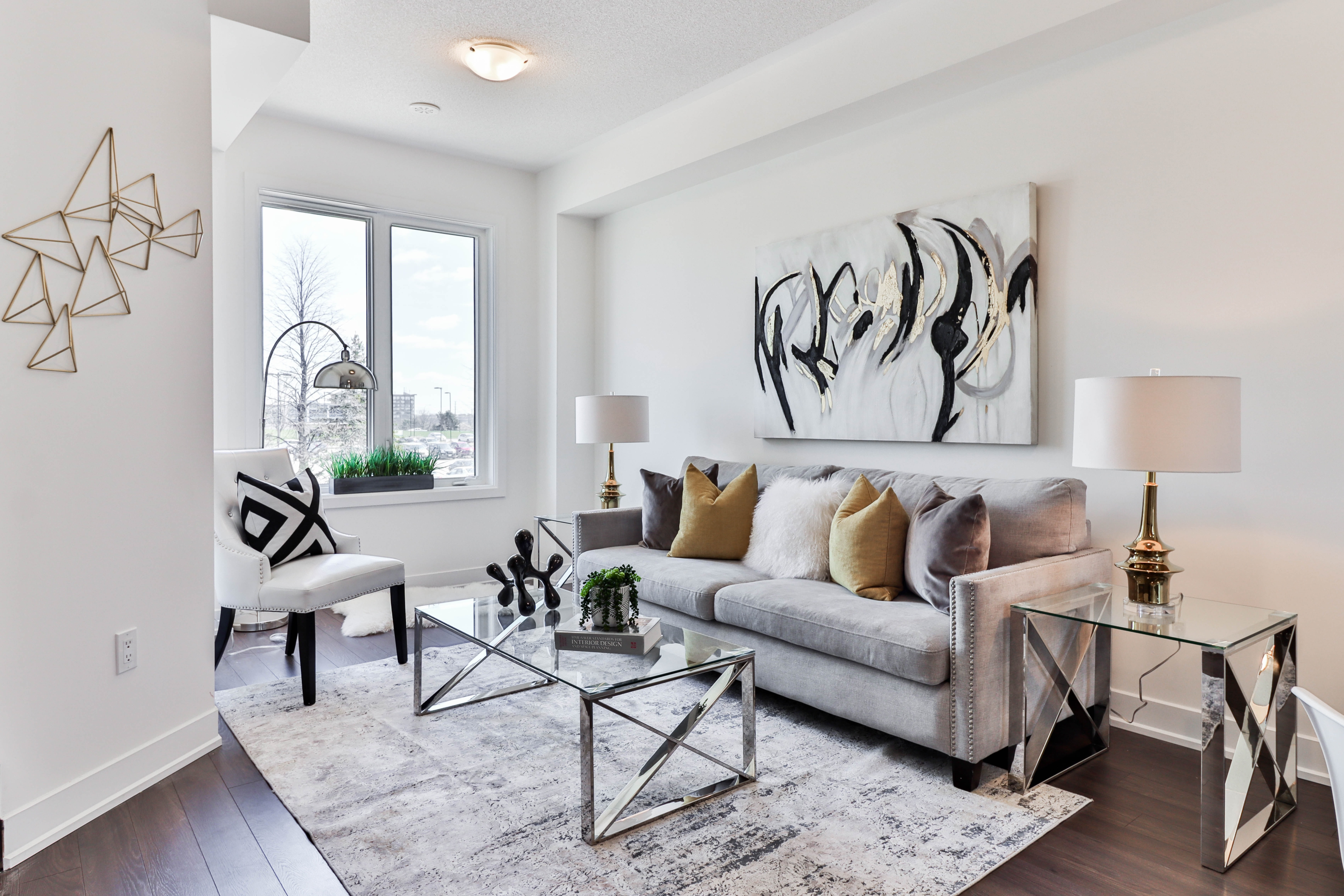 gray gold and white living room with side tables lamps and coffee table - image credit: https://unsplash.com/photos/SnHO-Ua7QtY