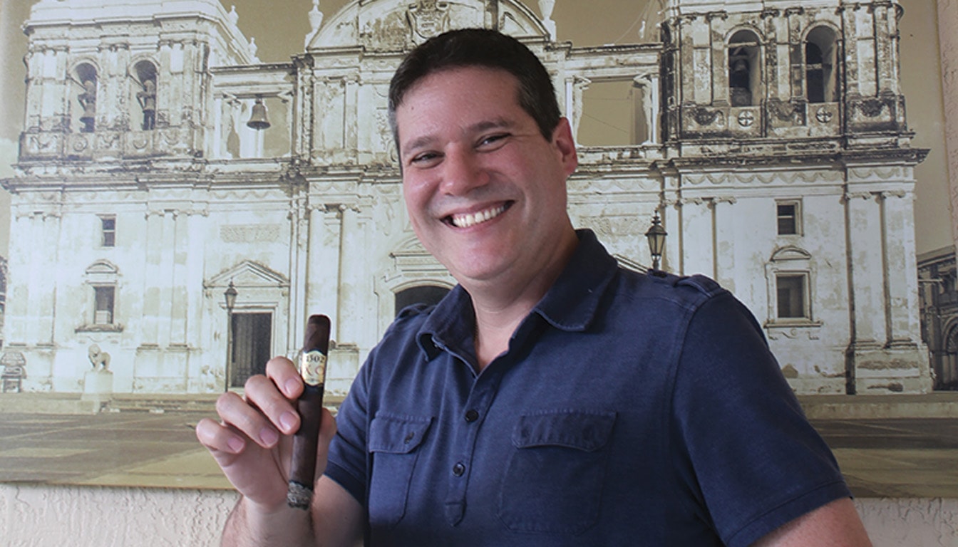 Enrique Sanchez, an artisan smoking a premium cigar.