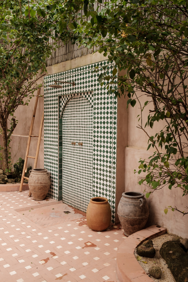 tile flooring outside in a windmill or hopscotch pattern with a door in one of our favorite tile patterns: green and white diamonds