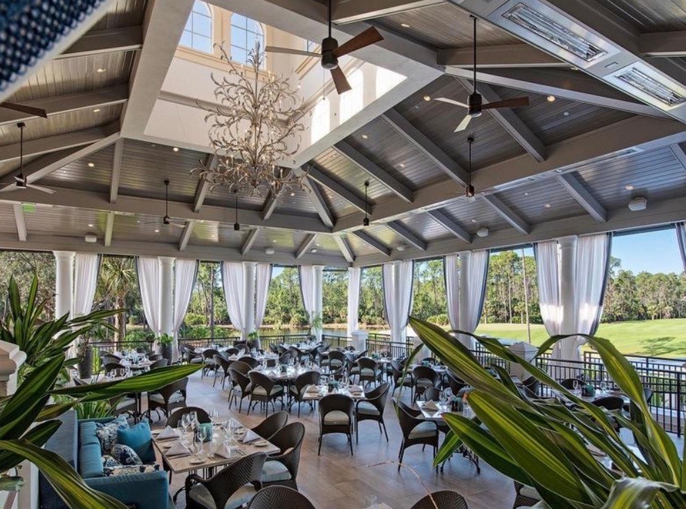 The image showcases a beautiful golf course view featuring pristine and mature landscaping, with sparkling water features enhancing the tranquil atmosphere. This serene outdoor living space is perfect for both entertaining and quiet relaxation, embodying the luxurious lifestyle found in a country club community.