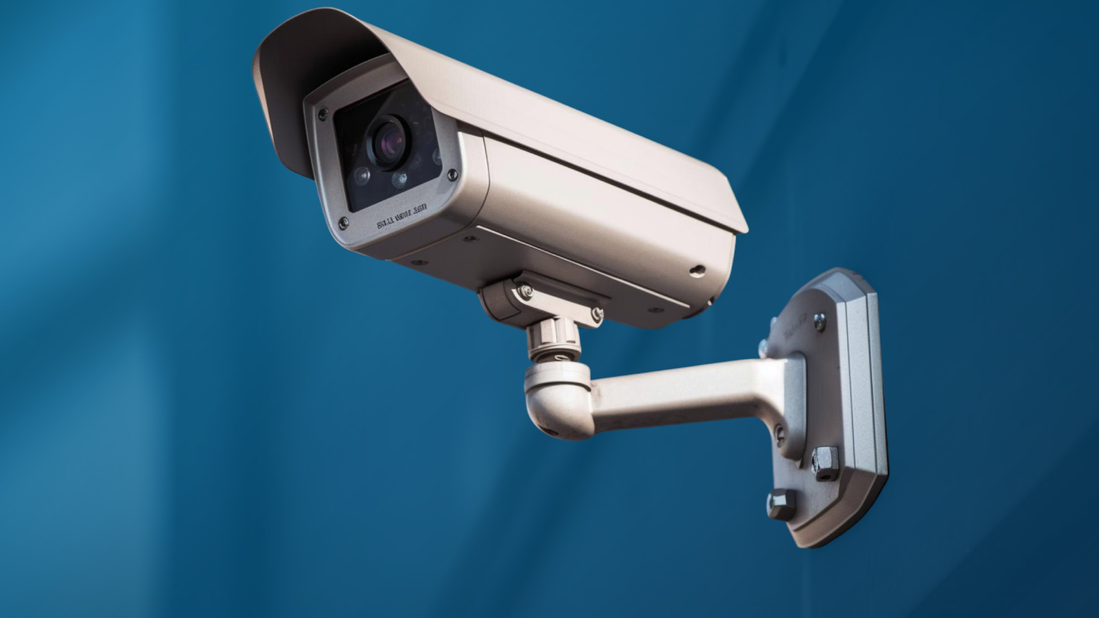 Wall-mounted security camera against a blue background, highlighting AI-powered security cameras and their role in advanced video analytics.
