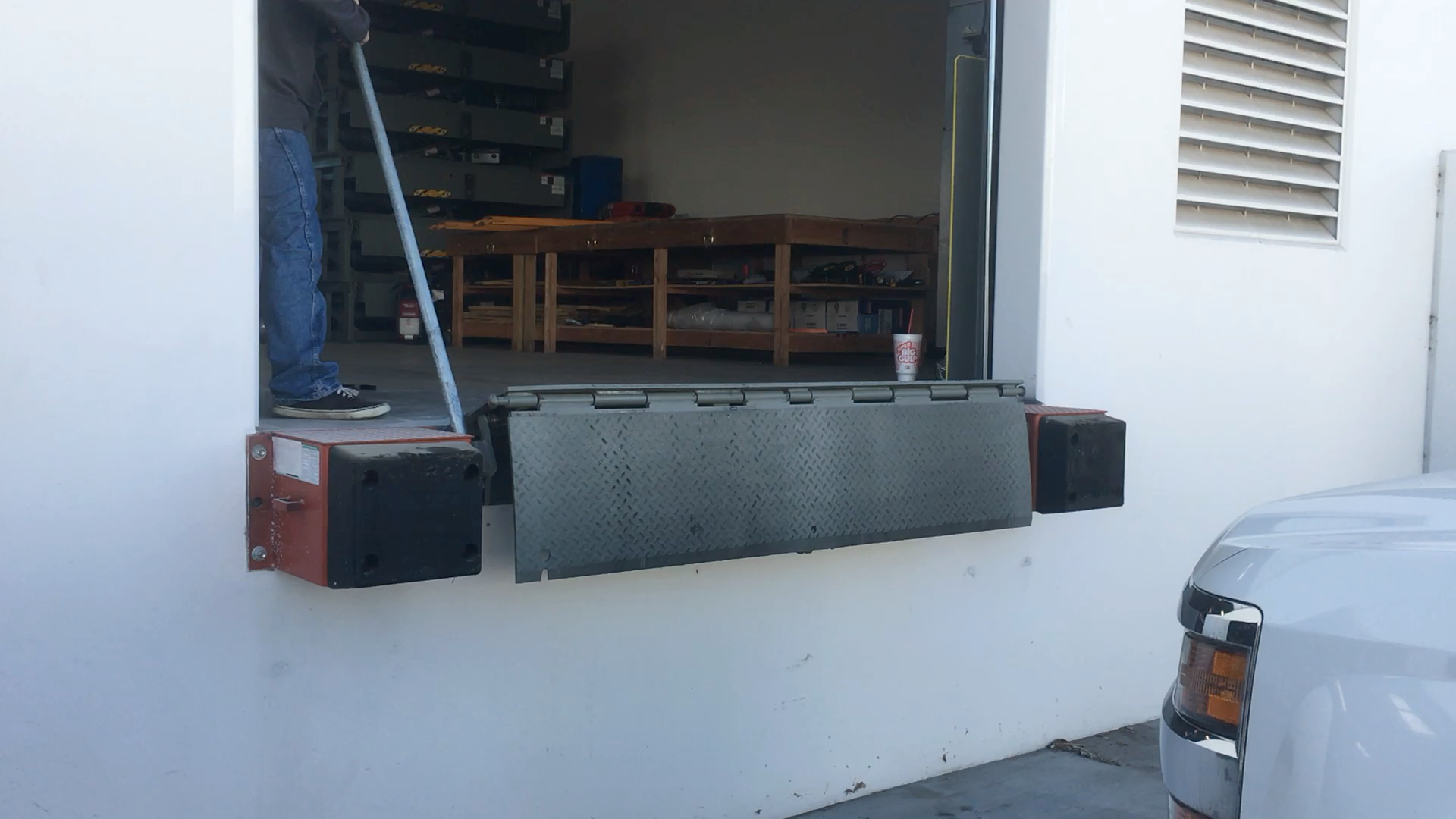 A loading dock with a dock leveler and a loading ramp