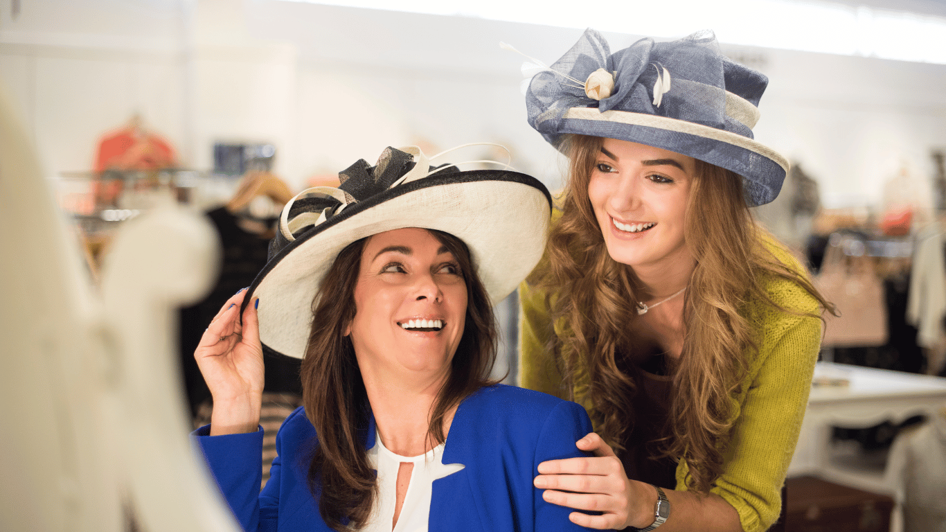 two women shopping for the perfect hat