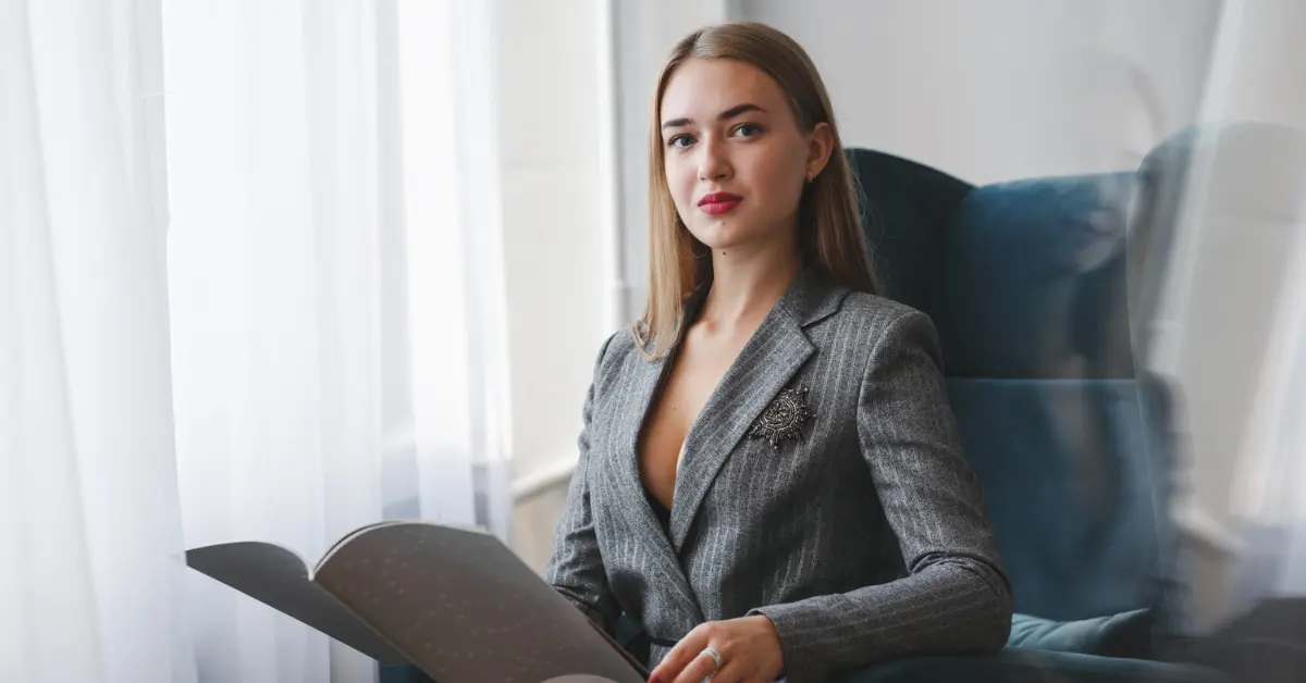 A female OnlyFans creator holding self-employment tax forms.