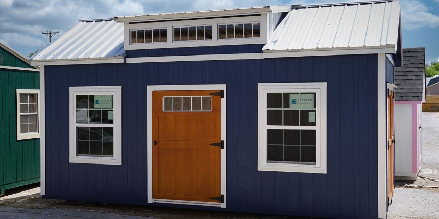 blue chalet shed with wood finished door