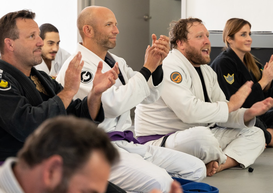 A picture of a Brazilian Jiu Jitsu practitioner wearing a purple belt and a black belt