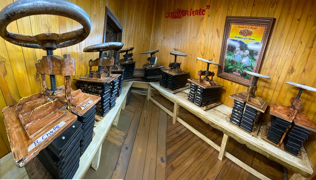 In a traditional workshop setting, a master cigar roller is meticulously crafting premium cigars, showcasing exceptional craftsmanship and rich flavors. This scene reflects the artistry involved in creating rare cigars, appealing to cigar enthusiasts who appreciate the unique blends and unforgettable smoking experiences that come from such dedication.
