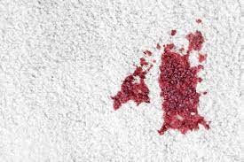 To remove a stubborn stain like red wine, apply ice cubes, then sprinkle baking soda, gently blot with a damp cloth with hydrogen peroxide.