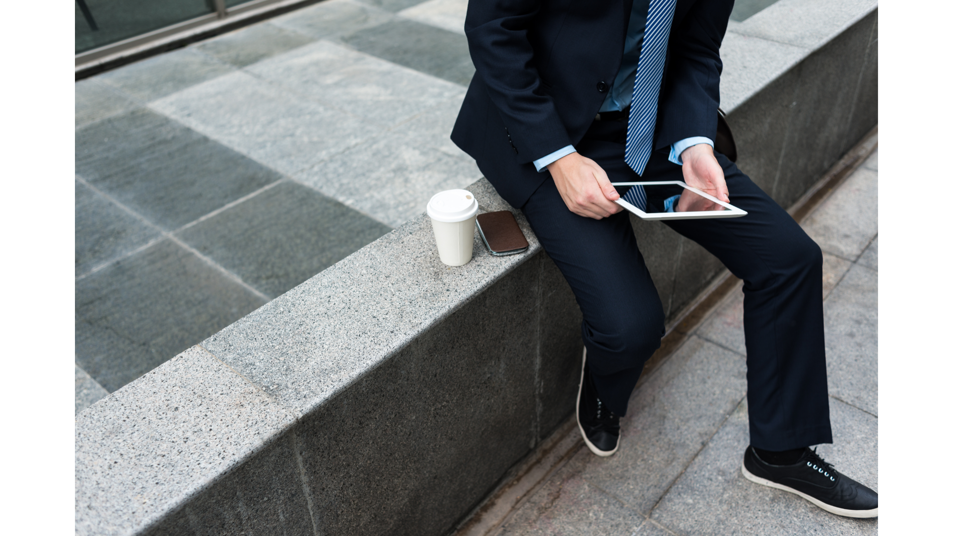 Capital gains tax - image 02 - man with a tablet in hand with a coffee and phone by his side
