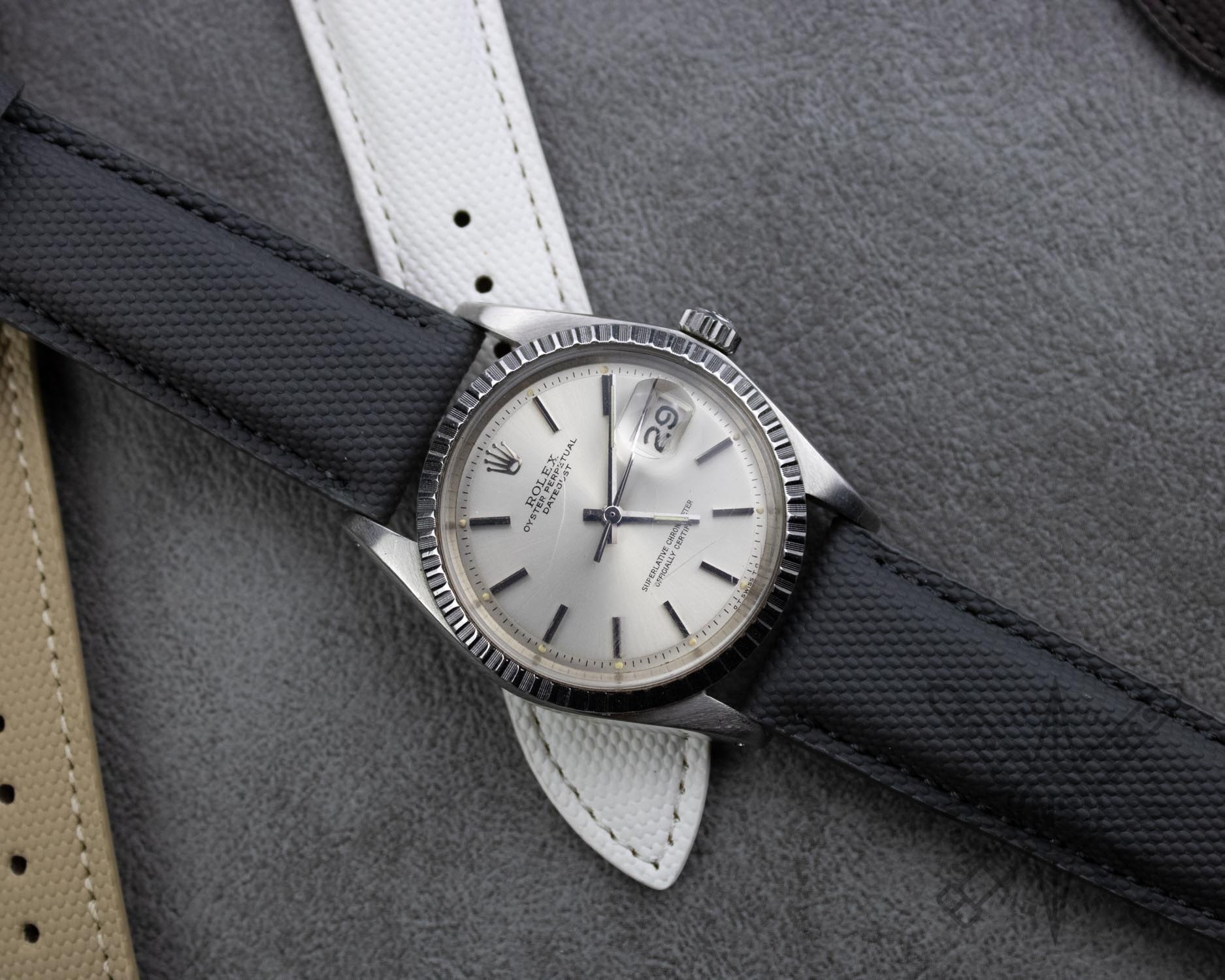 A person wearing a comfortable sailcloth watch strap on their wrist.
