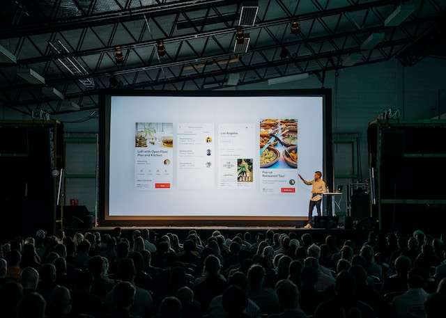 A man presenting in front of audience