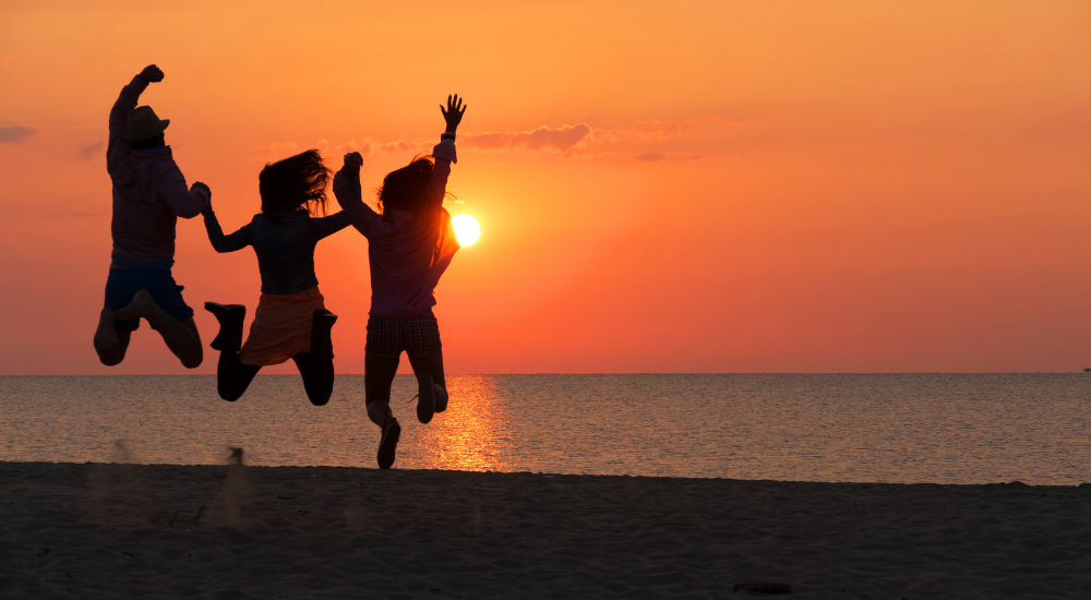 3 people jumping in joy