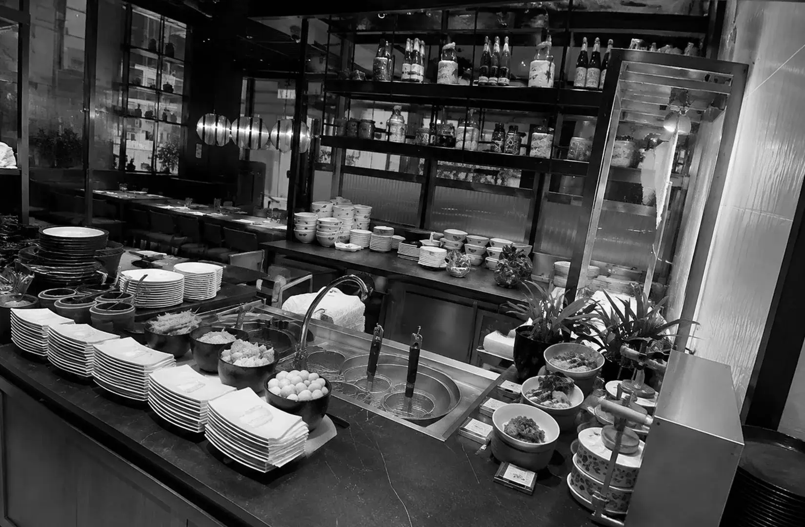 Modern buffet preparation station with assorted dishes and serving bowls