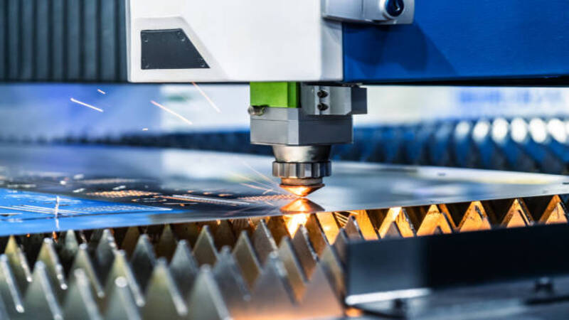 A laser cutter smoothly cutting a metal sheet.
