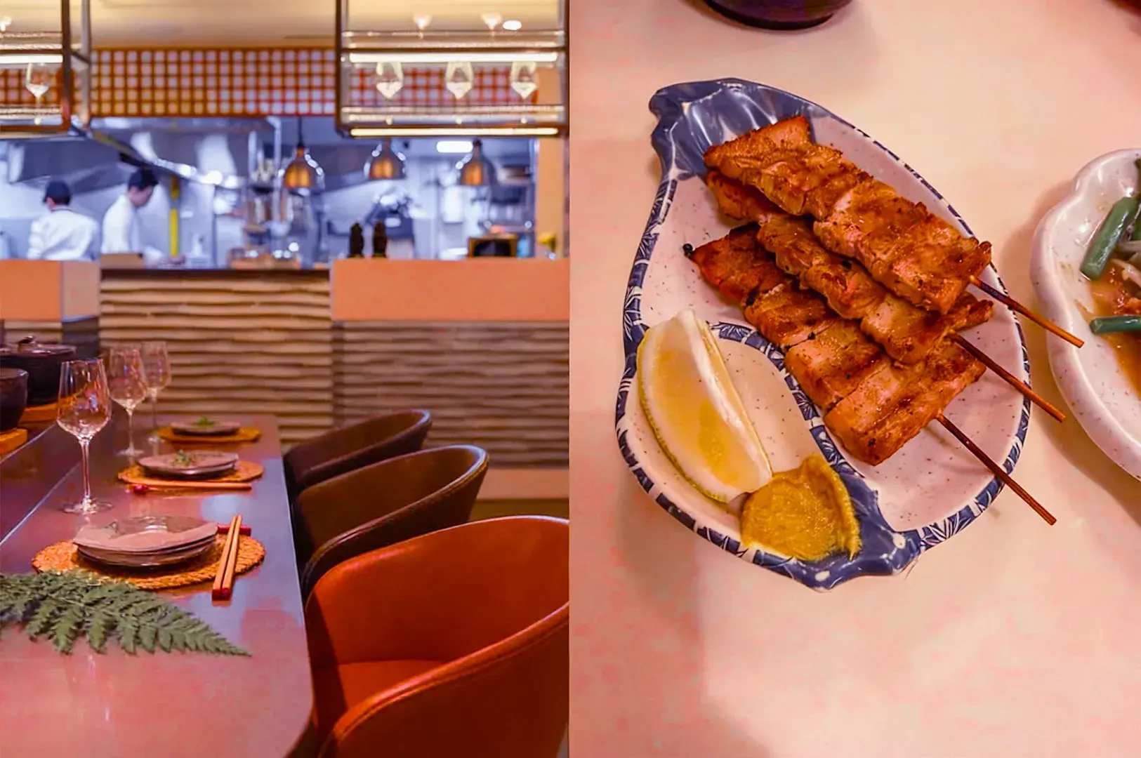 An elegant restaurant scene with a view of the open kitchen on the left, showing chefs at work. On the right, grilled skewers with lemon and mustard sit on a patterned plate. The setting conveys a warm, inviting ambiance.