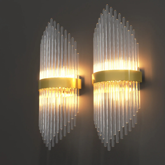 Pair of modern gold and crystal wall sconces casting warm light, perfect for adding elegance to a small dining room.