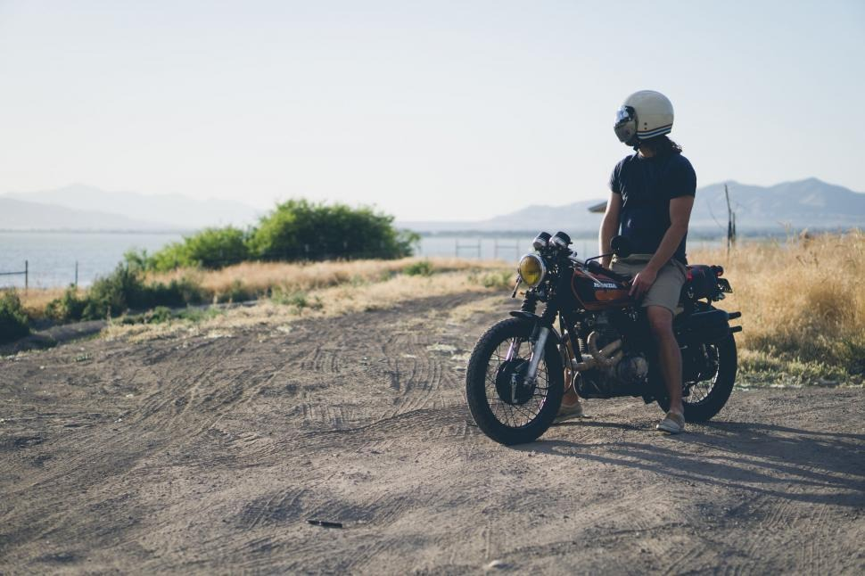 Person in motorcycle looking out the open field