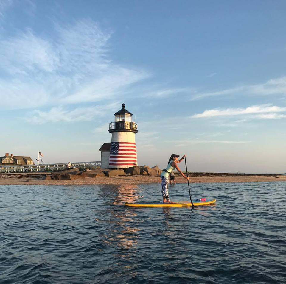 stand up paddle board by lighthouse