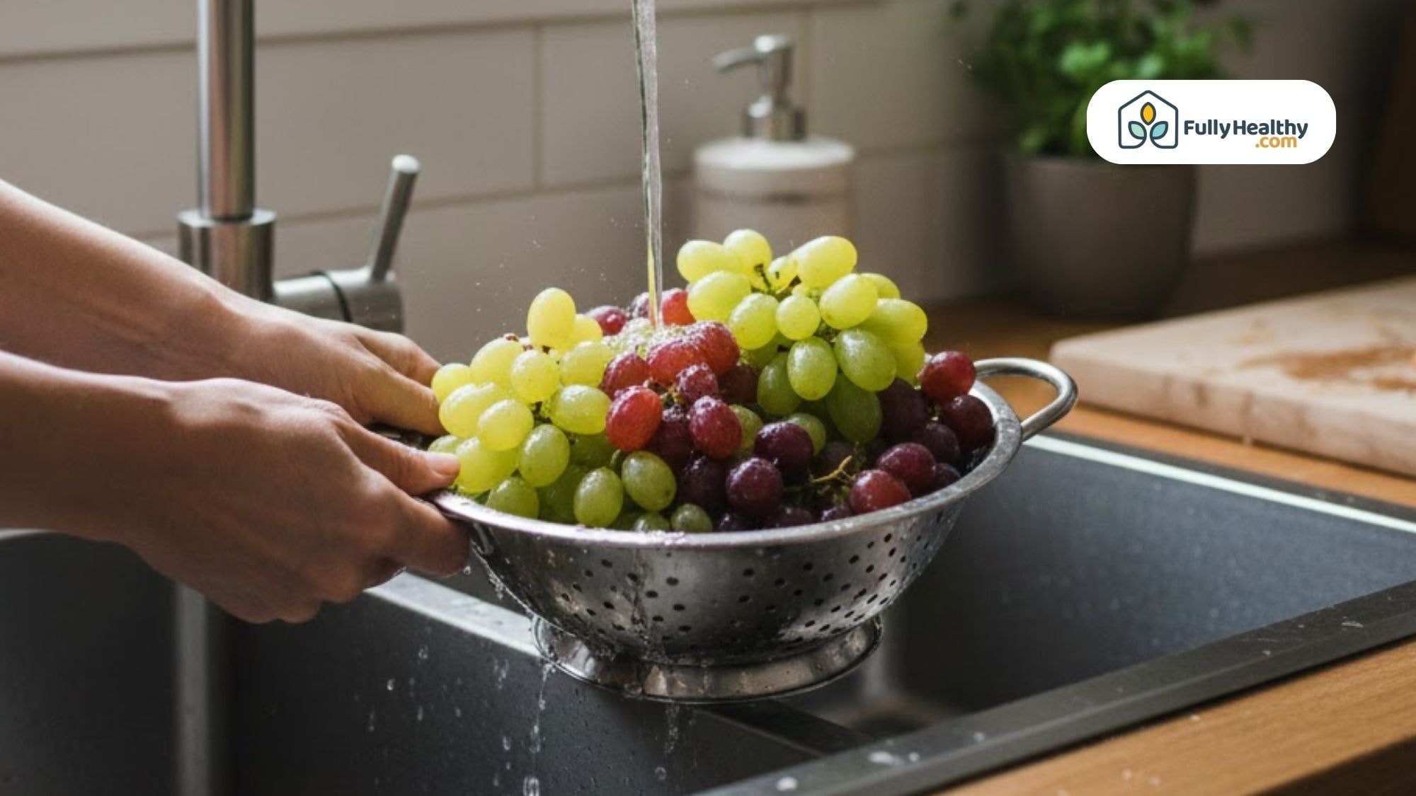 Washing green and red grapes in a colander under cool running water.