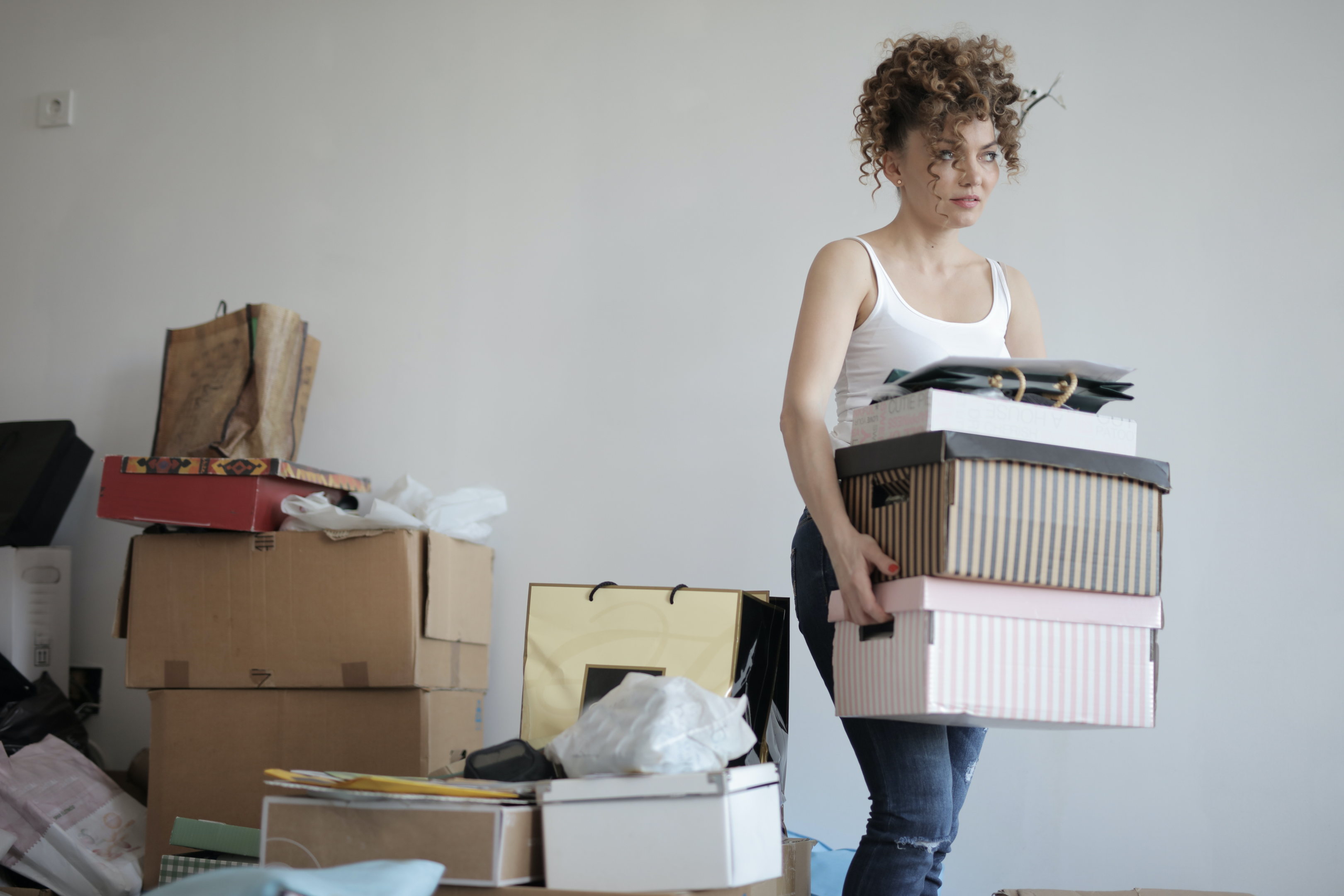 Photo by Andrea Piacquadio: https://www.pexels.com/photo/concentrated-woman-carrying-stack-of-cardboard-boxes-for-relocation-3791617/