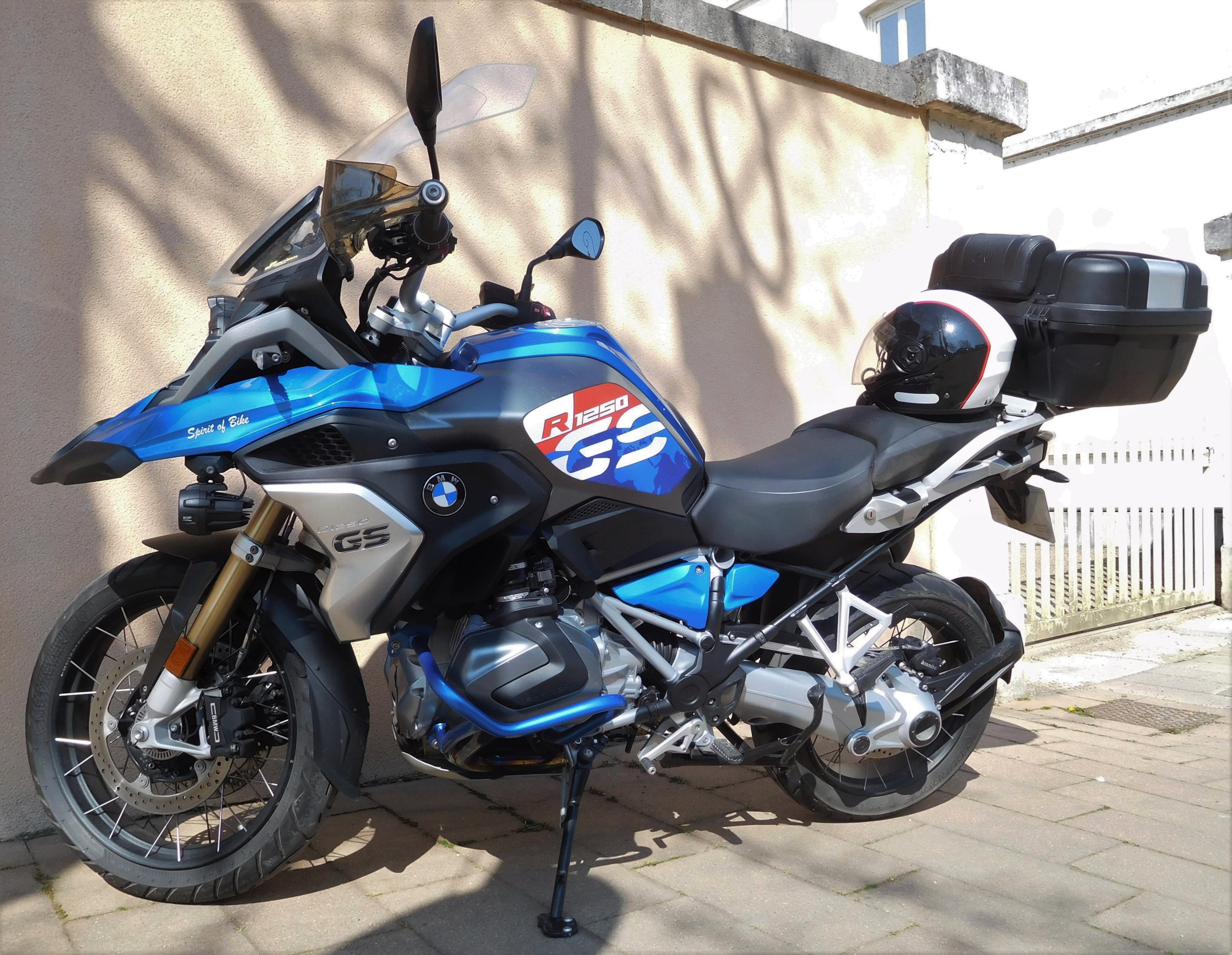 A BMW R 1250 GS motorcycle parked on the pavement