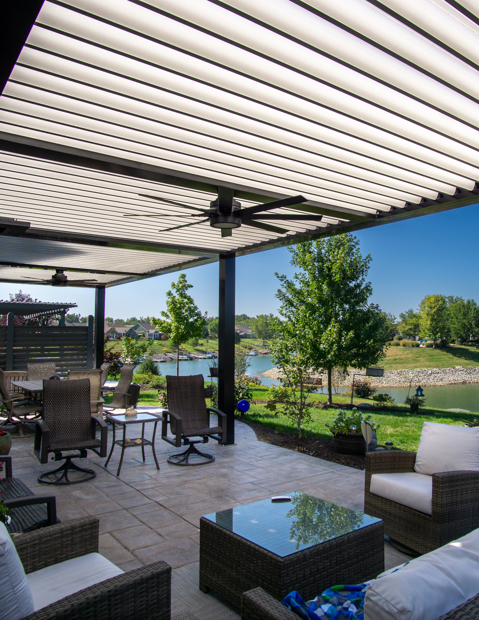 Outside living space made better with furniture features under pergola with louvered roof