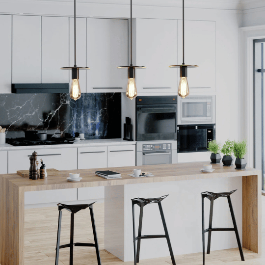 Contemporary kitchen with a wooden island and black barstools, illuminated by three industrial-style pendant lights with exposed Edison bulbs above.Contemporary kitchen with a wooden island and black barstools, illuminated by three industrial-style pendant lights with exposed Edison bulbs above.