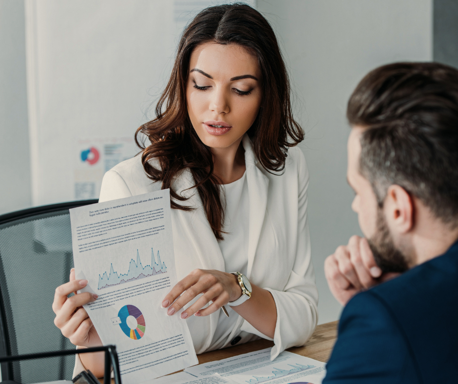 a woman sharing investment portfolio stats with a man