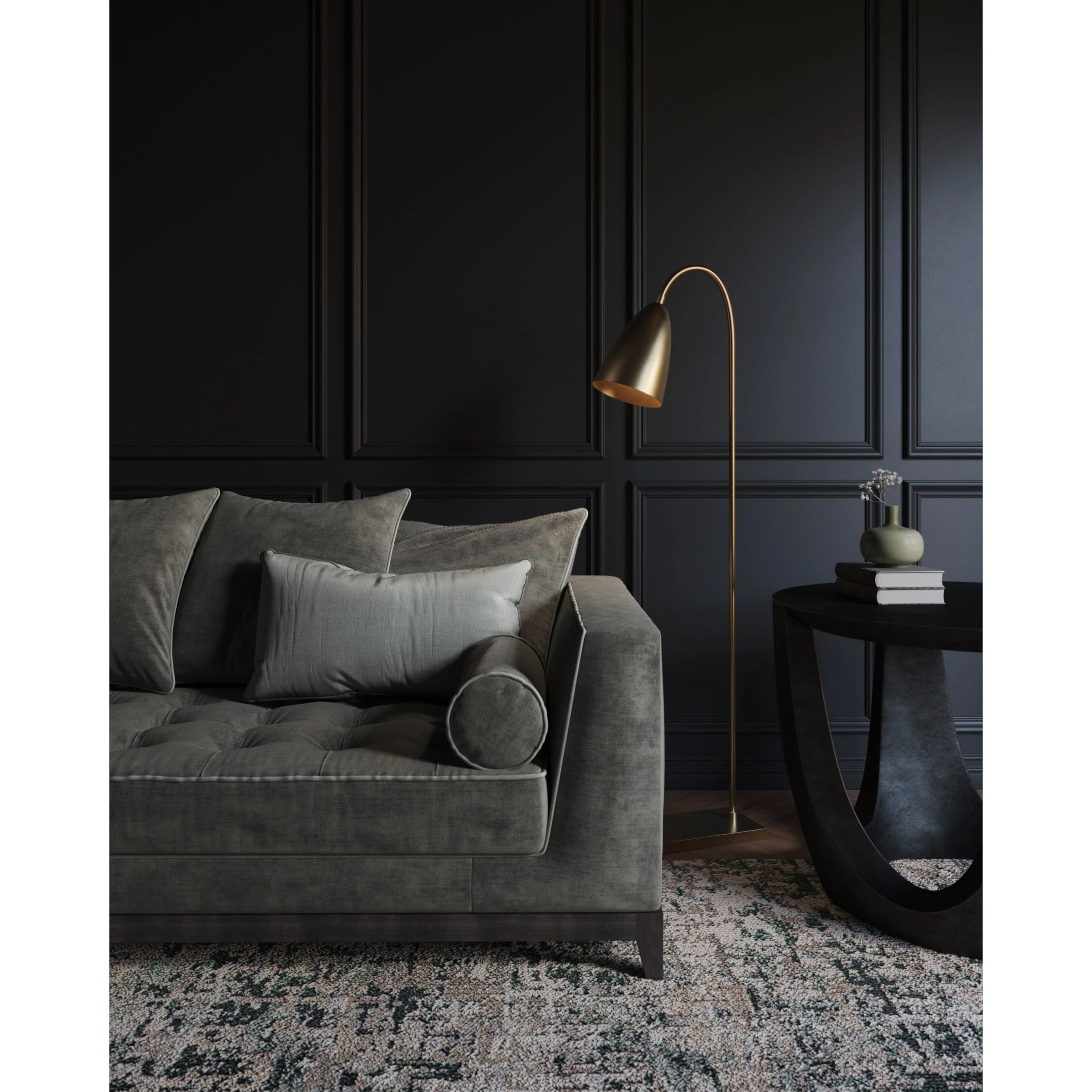 Sophisticated living room with a black wall, gold floor lamp, and grey velvet sofa.